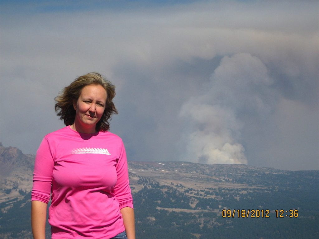 Hilkka Timonen and a distant fire plume seen from Mt. Bachelor, September 2012