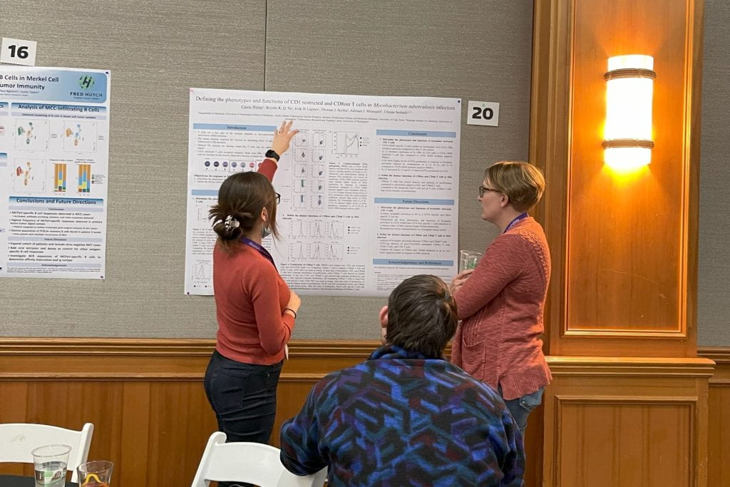 M3D PhD candidate Cassie Winter presenting poster to M3D PhD candidates Tori Tappen and Jacob Greene at the DLMP Department Retreat.