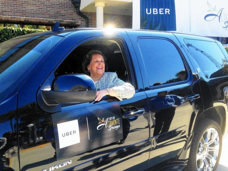 Altamonte Springs Mayor Patricia Bates sits at the wheel of an Uber vehicle at City Hall after announcing the new partnership between her city and the ride-sharing company. 
