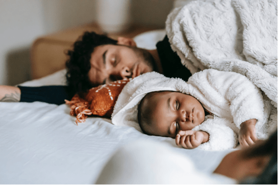 Man sleeping with infant