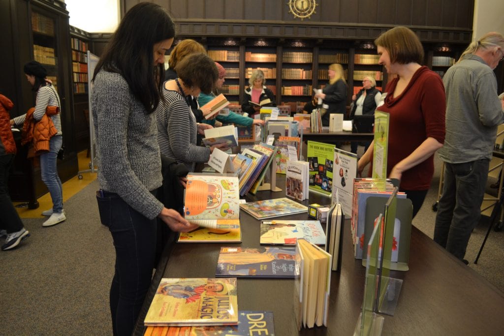 Visitors browse picture books at the children's literature open house