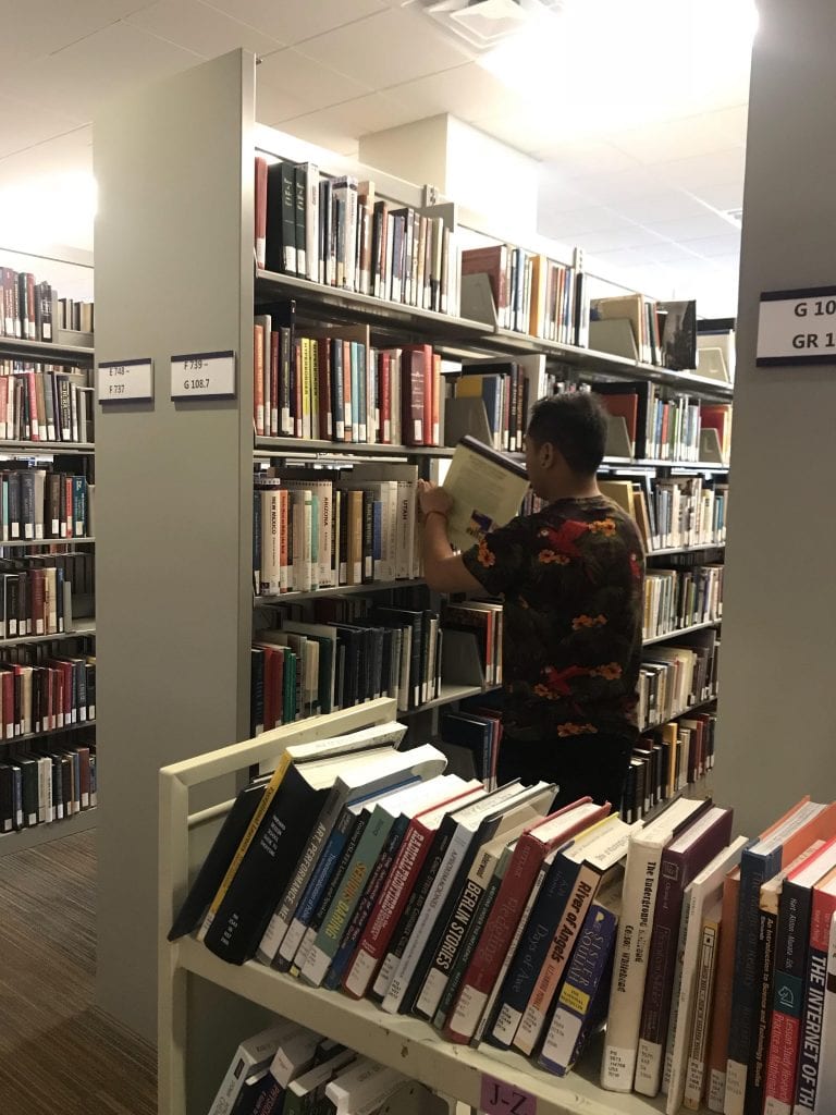 Shelving books in Tioga Library Building