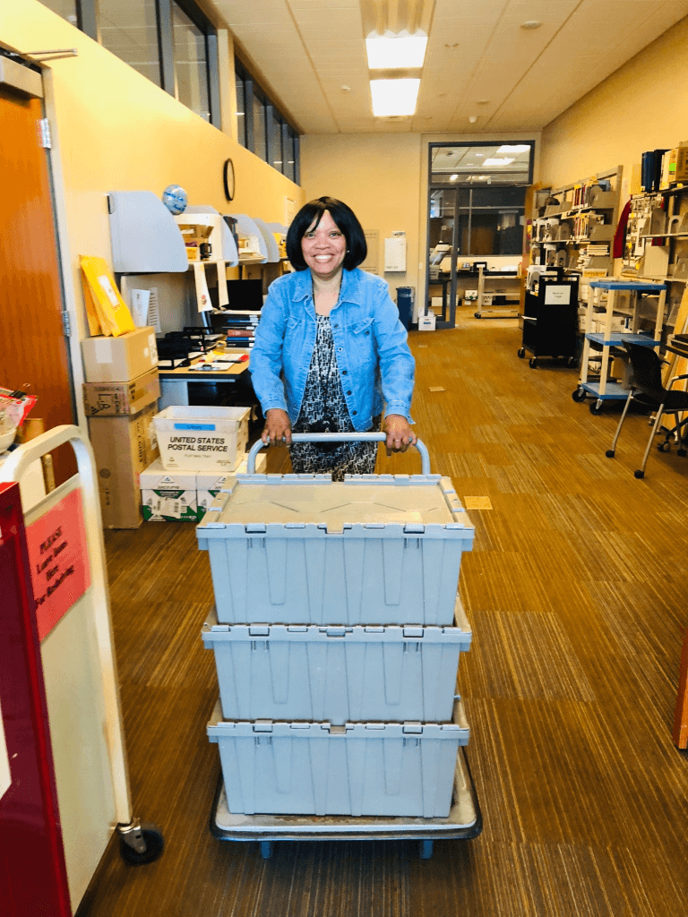 Student Supervisor in library with mail cart