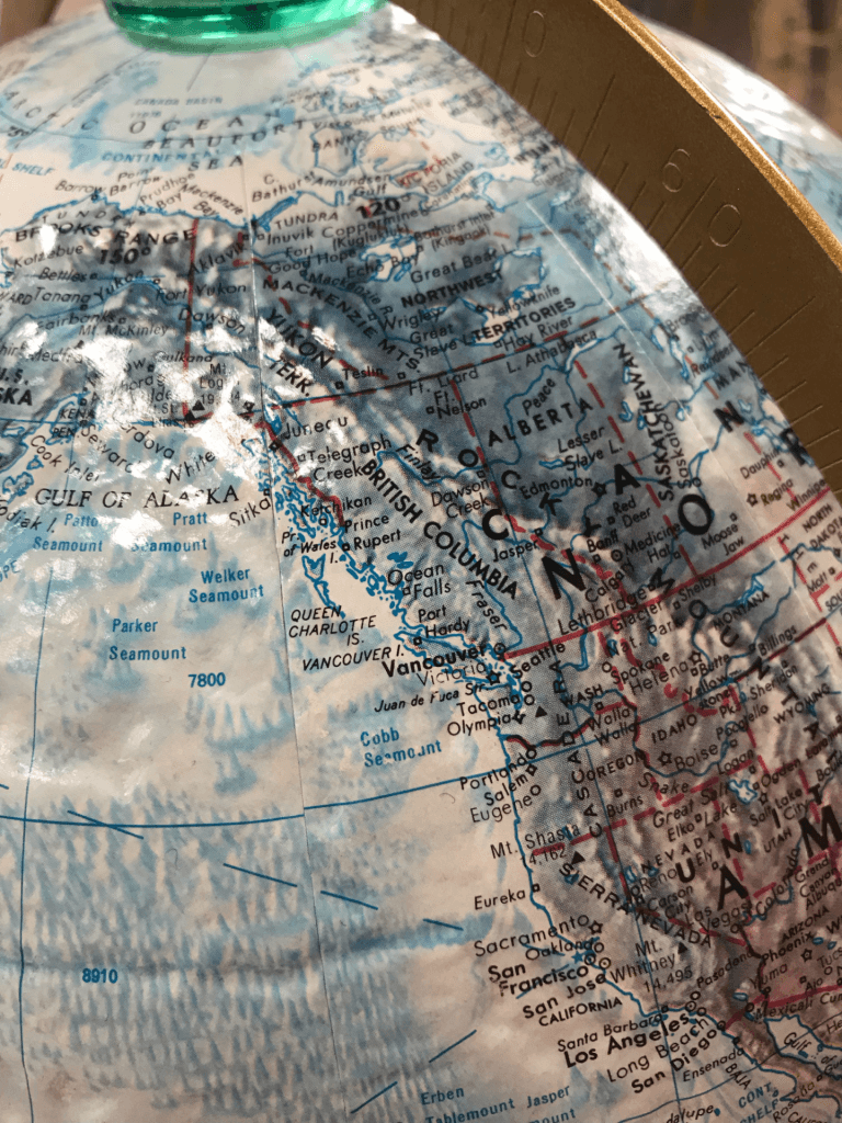 Photo of a globe focused in on Alaska and the Pacific Northwest