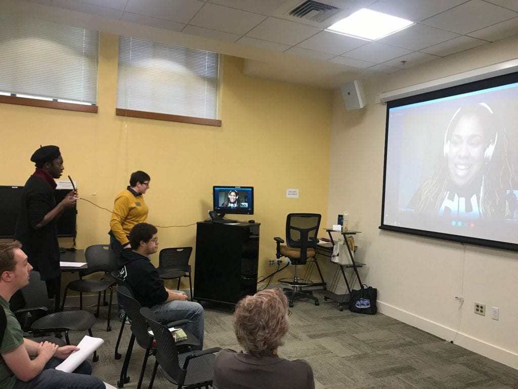 skype call on projected screen with an audience