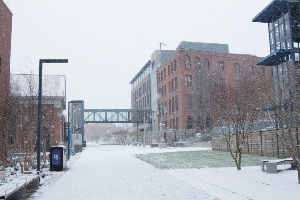 Photo of the prairie line trail at UW Tacoma in the snow, with the Tioga Library building in the distance.