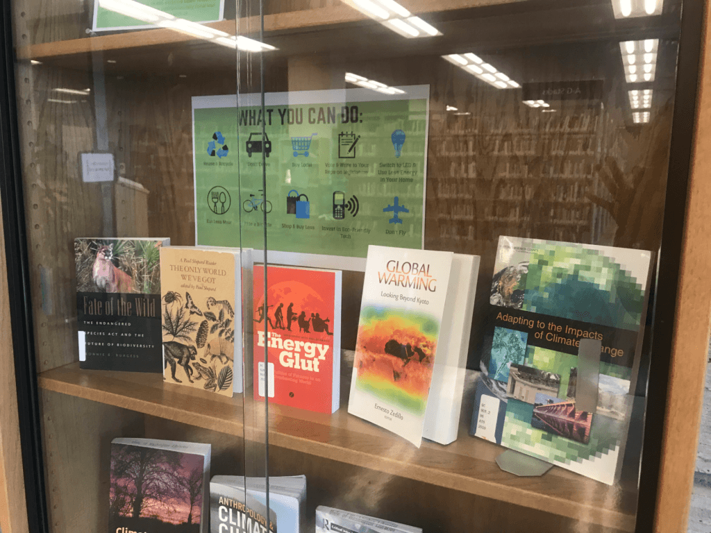 Photograph of a bookshelf with books about climate change.