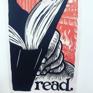 Woodblock print of a book being read with the word "read" below it. Colors are red, black and white.