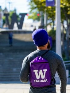 Photo of back of UW Tacoma student walking upstairs