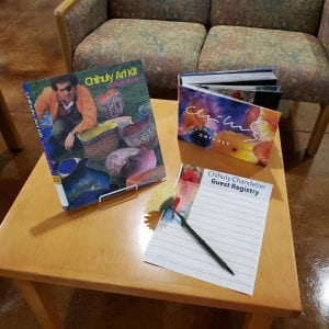 2 Chihuly books on a coffee table with a guest registry and pen