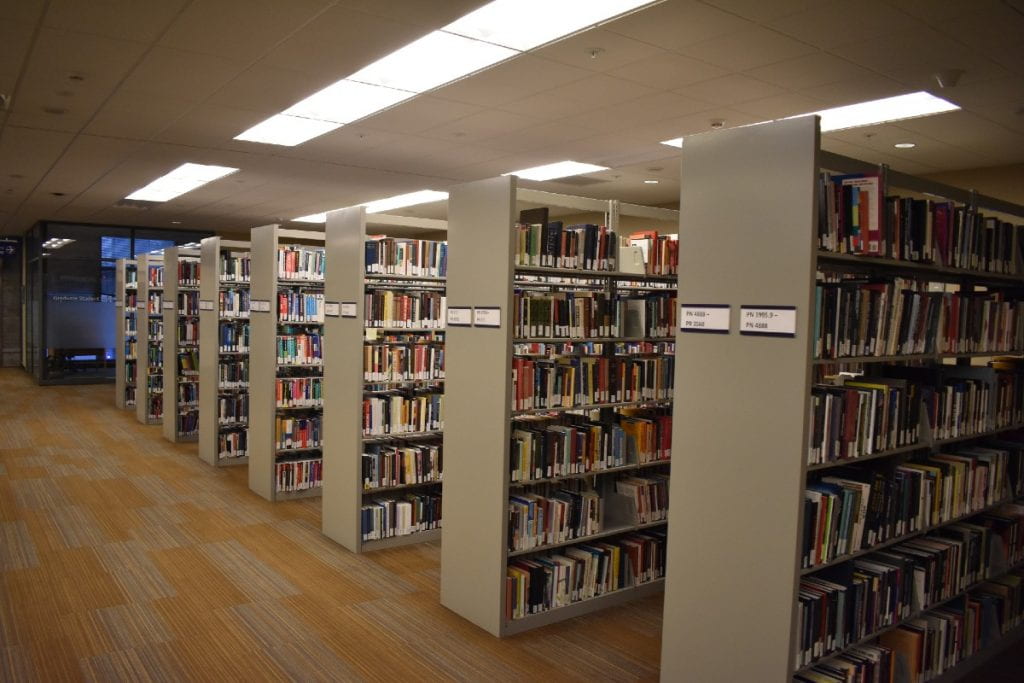 Photo of second floor of Tioga Library Building taken on January 11, 2021, showing ranges of book shelving.
