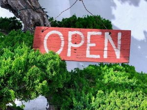 A wooden sign reading "Open."