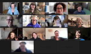Image is a screenshot of15 people in a zoom call, smiling. Names have been obscured for privacy reason. Two people do not have their camera on; one image is blurry.