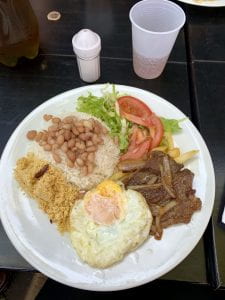 Brazilian lunch of beams, rice and fried eggs and flour. 