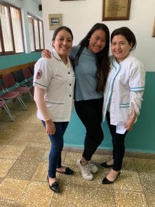 Adrianna posing with two hospital employees. 