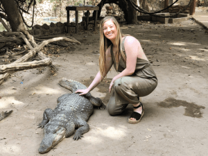 Alexis posing with a crocodile in The Gambia